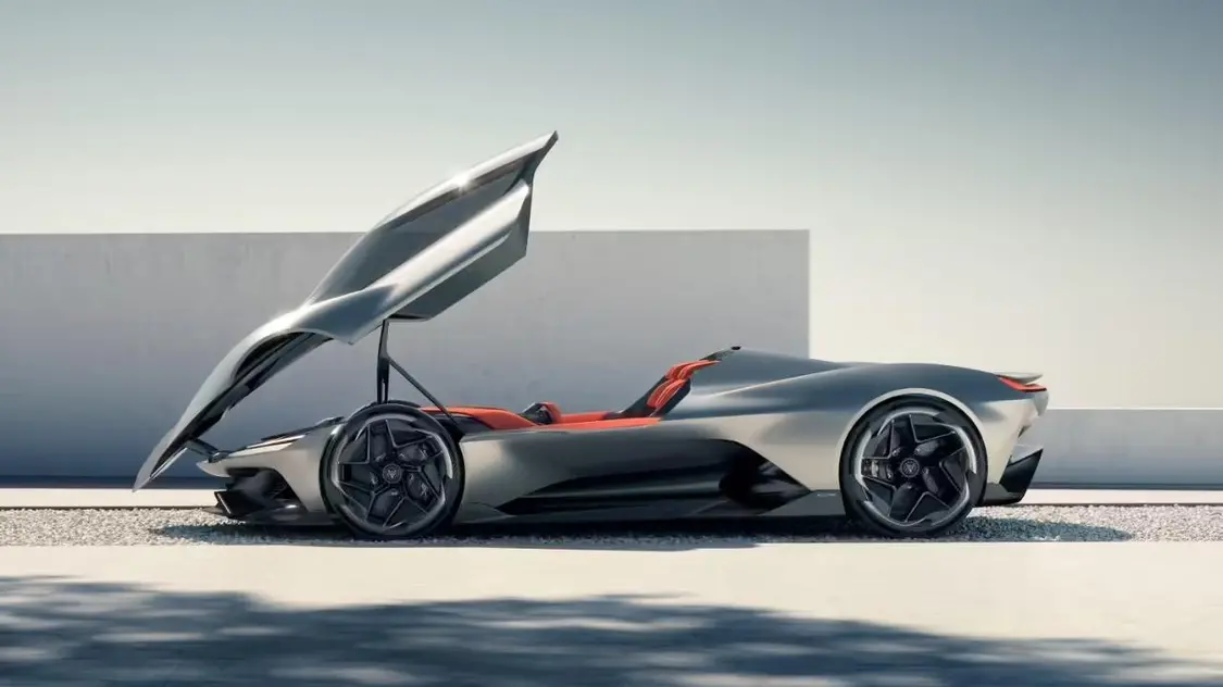 The interior and bucket seats of a silver convertible sports car.